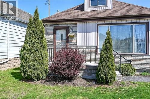 Exterior facade featuring stone veneer and vertical siding accents - 192 Ivon Avenue, Hamilton, ON - Outdoor