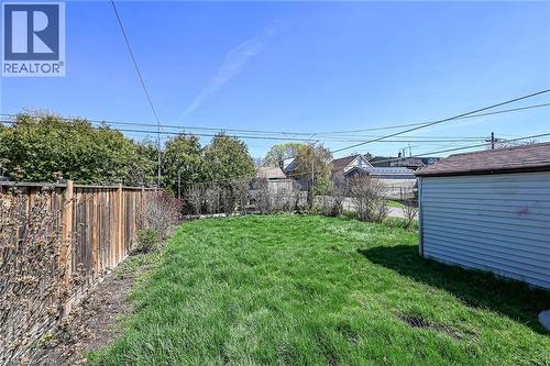 Expansive grassy yard area with a wood privacy fence - 192 Ivon Avenue, Hamilton, ON - Outdoor