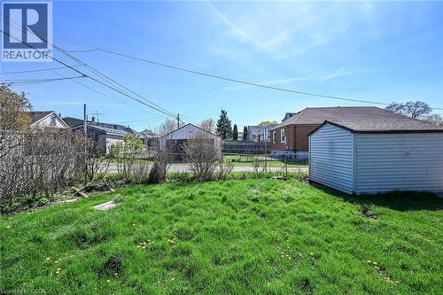 Spacious backyard featuring a detached outbuilding with horizontal siding and an asphalt shingle roof - 192 Ivon Avenue, Hamilton, ON - Outdoor