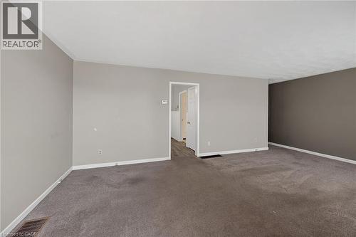 Spacious room featuring carpeting, neutral wall colors, and white trim - 192 Ivon Avenue, Hamilton, ON - Indoor Photo Showing Other Room