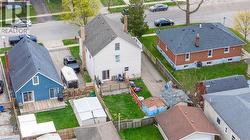 Rear of property featuring a spacious wood deck, direct access through sliding glass doors, and a detached shed - 