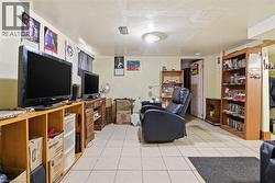 Recessed lighting and a flush mount fixture illuminate this space featuring tile flooring - 