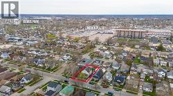 Aerial overview of the neighborhood, highlighting the property boundary - 