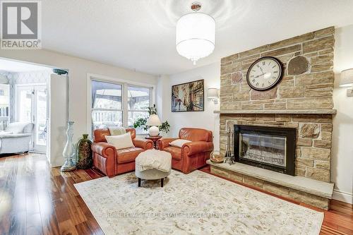 Stone floor to ceiling Fireplace - 1279 Old English Lane, Oakville, ON - Indoor Photo Showing Living Room With Fireplace