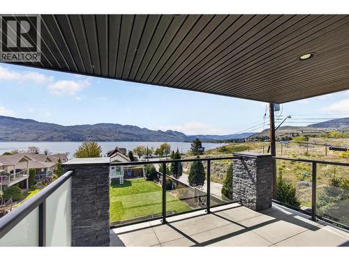 Multiple outdoor spaces to entertain, including two balconies and a patio, all with lake views. - 3859 Carrall Road, West Kelowna, BC 