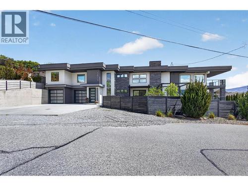 Plenty of parking with room for 6 vehicles in the driveway and 2 in the garage, plus an additional lower spot for an RV or trailer. - 3859 Carrall Road, West Kelowna, BC 