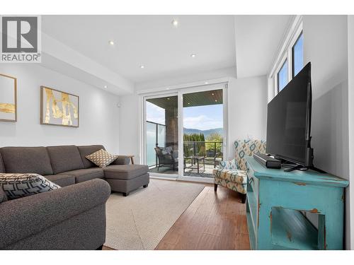 Seamlessly flows onto the balcony, featuring a great sitting area to take in the lake views. - 3859 Carrall Road, West Kelowna, BC 