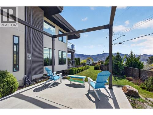 Perfect for entertaining on the patio with a gas hookup, lake views, and direct access to the yard. - 3859 Carrall Road, West Kelowna, BC 