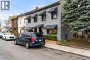Two-story residential facade featuring horizontal siding and dark window awnings - 11 Ford Street, Hamilton, ON  - Outdoor 