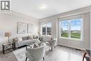 Bright living space featuring large windows, wood-finish flooring, white baseboards, and neutral wall tones - 50 Hollywood Court, Cambridge, ON  - Indoor Photo Showing Living Room 