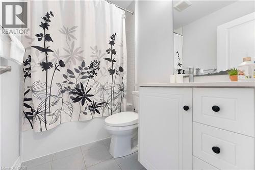 Bathroom featuring a white vanity with black hardware, a light-colored countertop, and a built-in sink with a chrome faucet - 50 Hollywood Court, Cambridge, ON - Indoor Photo Showing Bathroom