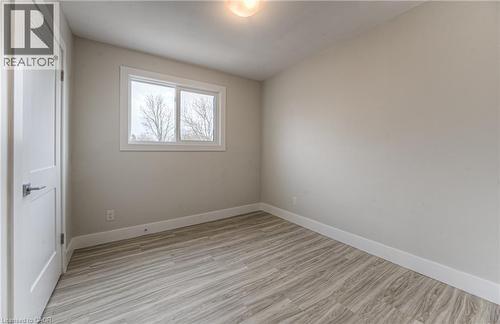 Room featuring wood-finish flooring, a double-paned window, neutral wall tones, and white trim - 40 Daniel Avenue Unit# 2, Kitchener, ON - Indoor Photo Showing Other Room