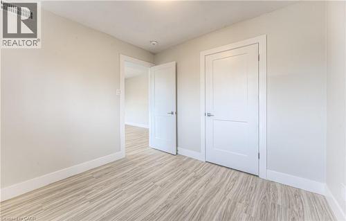 Light-toned wood-finish flooring complements the neutral wall color - 40 Daniel Avenue Unit# 2, Kitchener, ON - Indoor Photo Showing Other Room