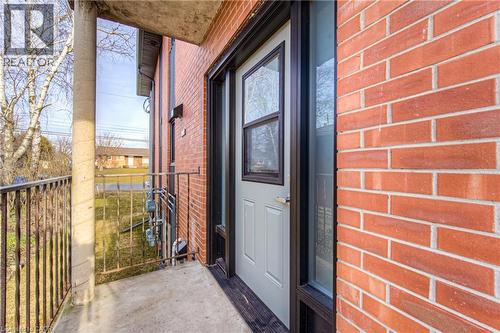 Exterior entrance featuring a light-colored door with a window insert, framed by a full-length sidelight - 40 Daniel Avenue Unit# 2, Kitchener, ON -  Photo Showing Other Room