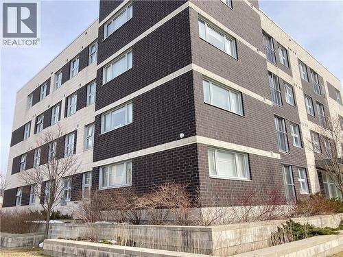 Contemporary multi-story building featuring a two-tone brick facade with light and dark brickwork - 392 Albert Street Unit# 302, Waterloo, ON - Outdoor