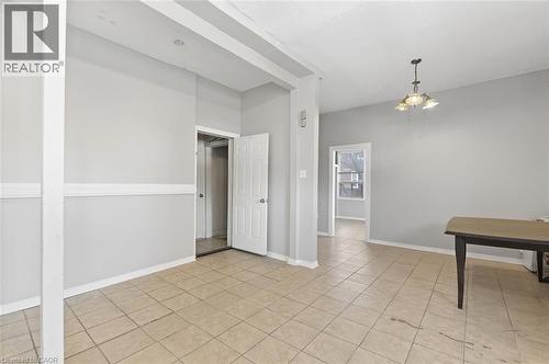 Spacious interior room featuring neutral-toned walls, tile flooring, and white trim - 238-242 King Street E, Hamilton, ON 