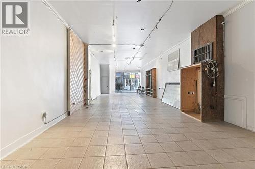 Expansive open-concept interior featuring light-toned square tile flooring throughout - 238-242 King Street E, Hamilton, ON 