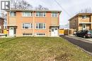 Brick and stucco exterior featuring multiple windows, a front lawn, and a paved driveway - 2337 Barclay Road, Burlington, ON  - Outdoor 