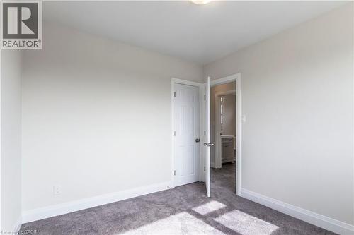 Room featuring neutral wall paint, gray carpet flooring, white baseboards, and a white interior door - 2337 Barclay Road, Burlington, ON - Indoor Photo Showing Other Room