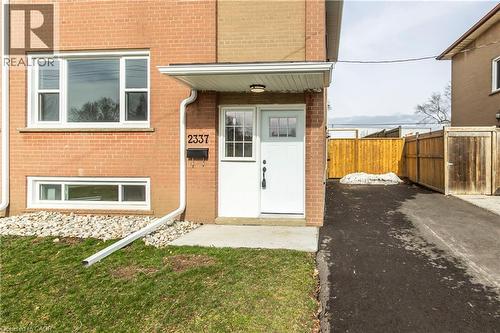 Brick exterior with white trim windows and a covered entry - 2337 Barclay Road, Burlington, ON - Outdoor With Exterior
