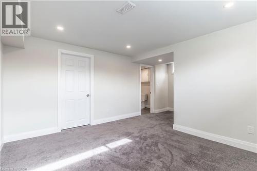 Spacious room featuring gray carpeted flooring, light gray wall paint, and recessed lighting - 2337 Barclay Road, Burlington, ON - Indoor Photo Showing Other Room