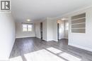 Open-concept living area featuring wood-finish flooring, recessed lighting, crown molding, built-in shelving, and white trim - 2337 Barclay Road, Burlington, ON  - Indoor Photo Showing Other Room 