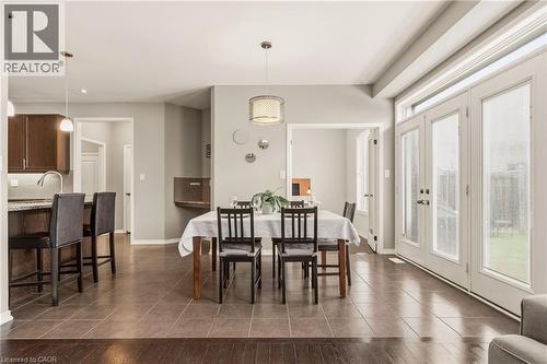 Dining area featuring an open concept design, tiled flooring, and double patio doors with transom windows - 42 Yager Drive, Binbrook, ON - Indoor Photo Showing Dining Room
