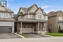 Two-story residence featuring brick and siding facade, covered front porch, and an attached two-car garage - 42 Yager Drive, Binbrook, ON  - Outdoor With Facade 