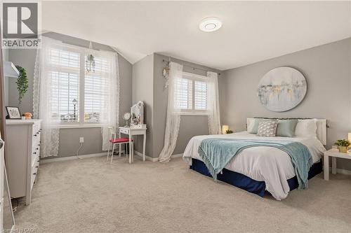 Spacious bedroom featuring light neutral wall tones and soft carpet flooring - 42 Yager Drive, Binbrook, ON - Indoor Photo Showing Bedroom