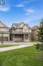 Two-story residence featuring a combination of brick and siding, a covered porch entrance, and an attached two-car garage - 42 Yager Drive, Binbrook, ON  - Outdoor With Facade 