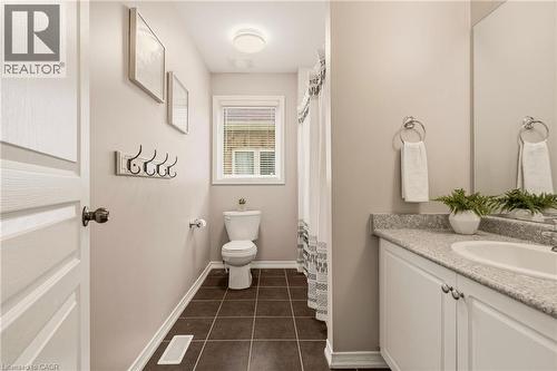 Bathroom featuring a vanity with an integrated sink, a large wall-mounted mirror, and white cabinetry - 42 Yager Drive, Binbrook, ON - Indoor Photo Showing Bathroom