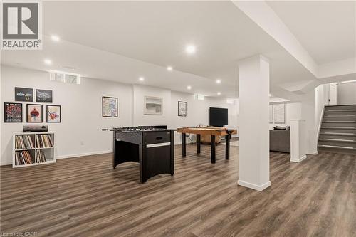 Spacious lower level featuring wood-finish flooring, recessed lighting, and a white color palette - 42 Yager Drive, Binbrook, ON - Indoor Photo Showing Other Room