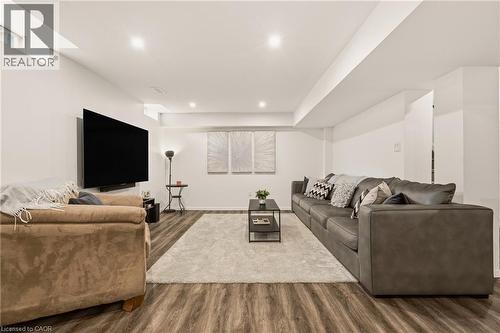 Spacious entertainment area featuring wood-finish flooring, recessed lighting, and crisp white walls - 42 Yager Drive, Binbrook, ON - Indoor Photo Showing Living Room