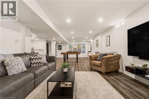 Expansive recreation room featuring wood-finish flooring, recessed lighting, and white painted walls - 42 Yager Drive, Binbrook, ON - Indoor Photo Showing Living Room