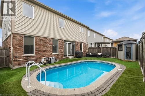 Oval-shaped inground pool with paver surround and integrated steps - 42 Yager Drive, Binbrook, ON - Outdoor With In Ground Pool With Backyard With Exterior