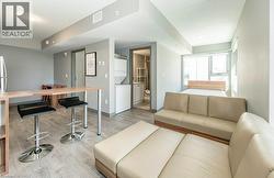 Open-concept living space with light wood-finish flooring - 