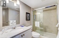 Bathroom featuring a single vanity with an integrated sink, polished chrome faucet, and speckled countertop - 