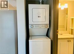 Dedicated laundry area with a stacked washer and dryer unit - 