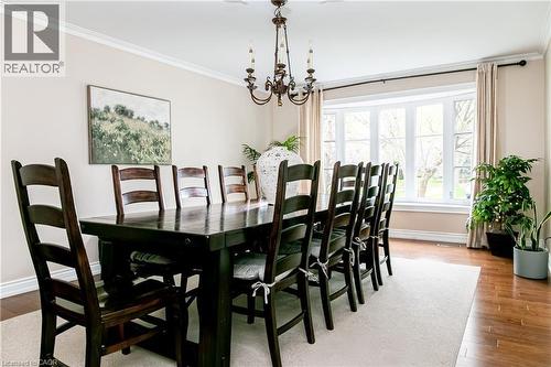 Formal dining area featuring a bay window with ample natural light, crown molding, and wood-finish flooring - 1577 Old Spar Court, Mississauga, ON - Indoor Photo Showing Dining Room
