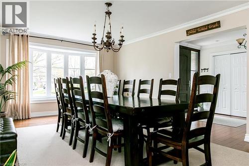 Spacious dining area featuring a bay window, hardwood flooring, and a decorative chandelier - 1577 Old Spar Court, Mississauga, ON - Indoor Photo Showing Dining Room