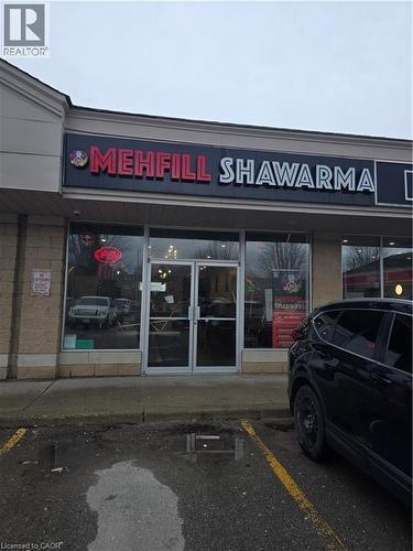 Commercial storefront featuring a prominent lighted sign, large glass display windows, and a double-door entrance - 100 Mearns Avenue Unit# 5, Clarington, ON 