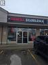 Commercial storefront featuring a prominent lighted sign, large glass display windows, and a double-door entrance - 100 Mearns Avenue Unit# 5, Clarington, ON 