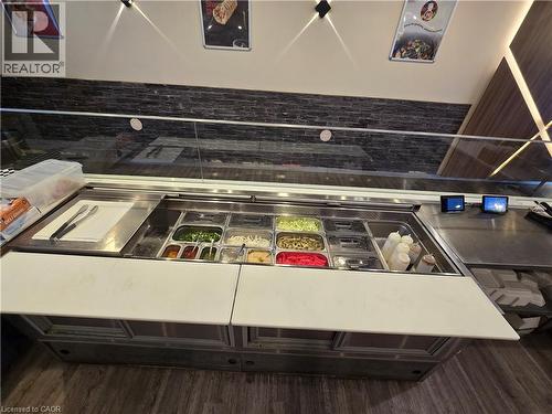 Stainless steel counter with built-in food prep stations featuring multiple ingredient bins - 100 Mearns Avenue Unit# 5, Clarington, ON 