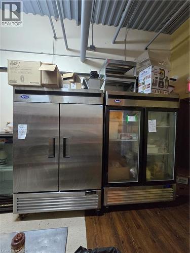Commercial-grade stainless steel double-door refrigerator alongside a glass-front display cooler - 100 Mearns Avenue Unit# 5, Clarington, ON 