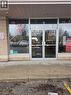 Commercial storefront featuring a glass entry door with a transom, large display windows, and a brick facade - 100 Mearns Avenue Unit# 5, Clarington, ON 