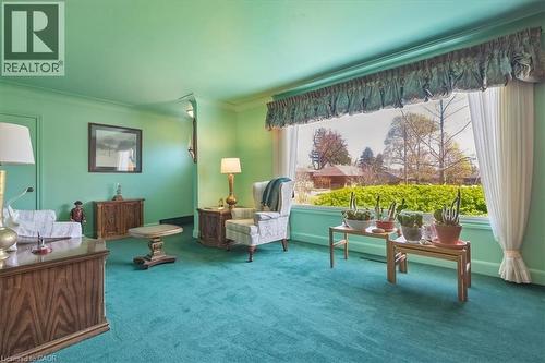 Green-hued walls and carpeting complement a large picture window - 2117 Edinburgh Drive, Burlington, ON - Indoor