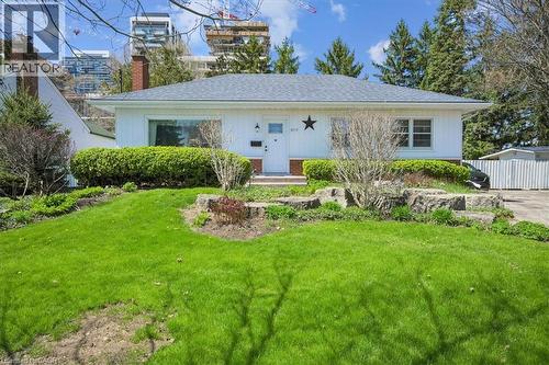 Ranch-style residence featuring white siding and a dark shingle roof - 2117 Edinburgh Drive, Burlington, ON - Outdoor