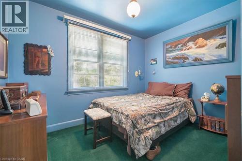 Interior room featuring blue painted walls, green carpeting, and a window with horizontal blinds - 2117 Edinburgh Drive, Burlington, ON - Indoor Photo Showing Bedroom
