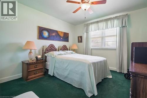 Bedroom featuring green carpeting, a ceiling fan with integrated lighting, and a double window with blinds and valance - 2117 Edinburgh Drive, Burlington, ON - Indoor Photo Showing Bedroom