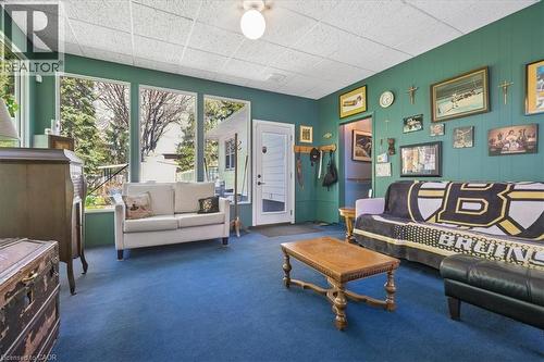 Sunroom featuring multiple windows, blue carpet flooring, a drop ceiling, and an exterior door - 2117 Edinburgh Drive, Burlington, ON - Indoor Photo Showing Living Room